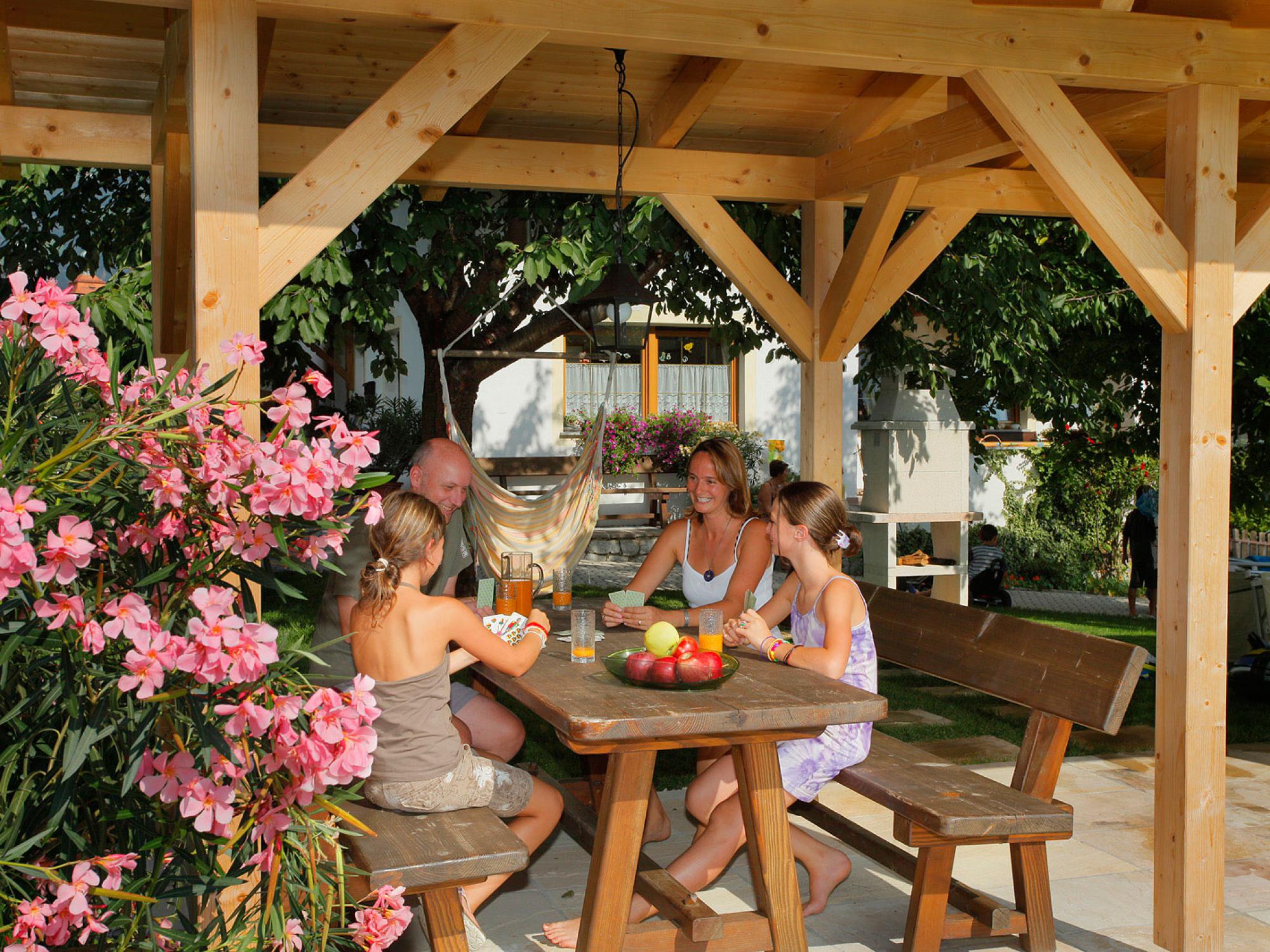 Playing cards in the roofed sitting area in our garden